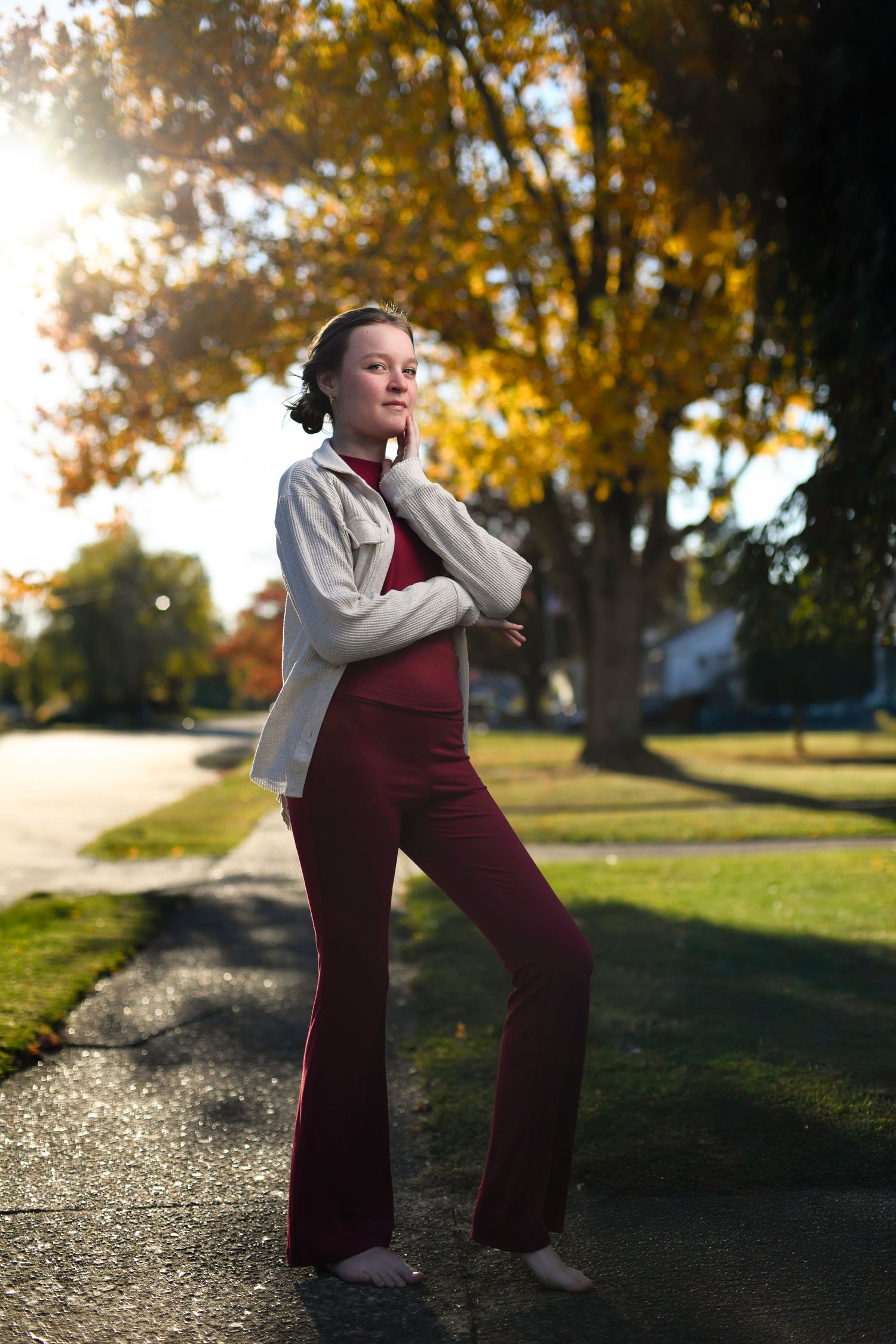 Full body portrait with crisp flash lighting and soft golden background captured using high-speed sync technique.