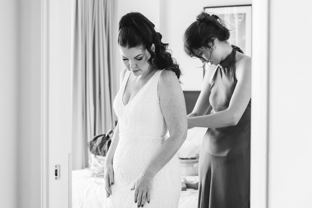 Getting ready scene showing preparations before wedding ceremony in bright room.