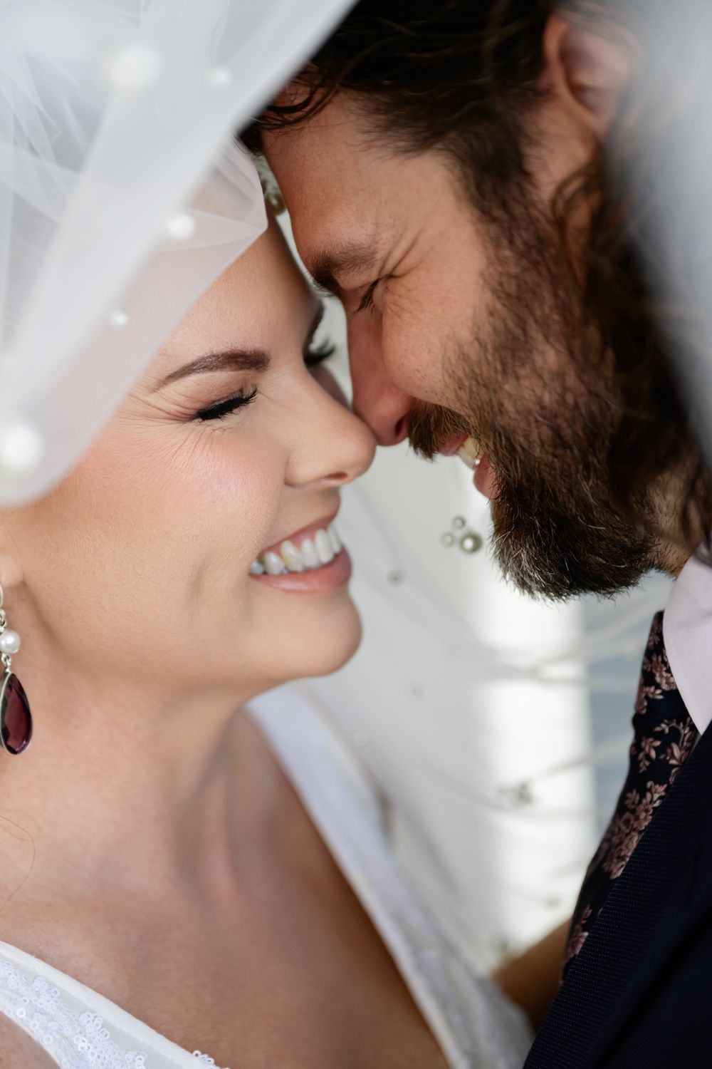 A romantic close-up sequence of a bride and groom sharing intimate moments during their wedding photoshoot.