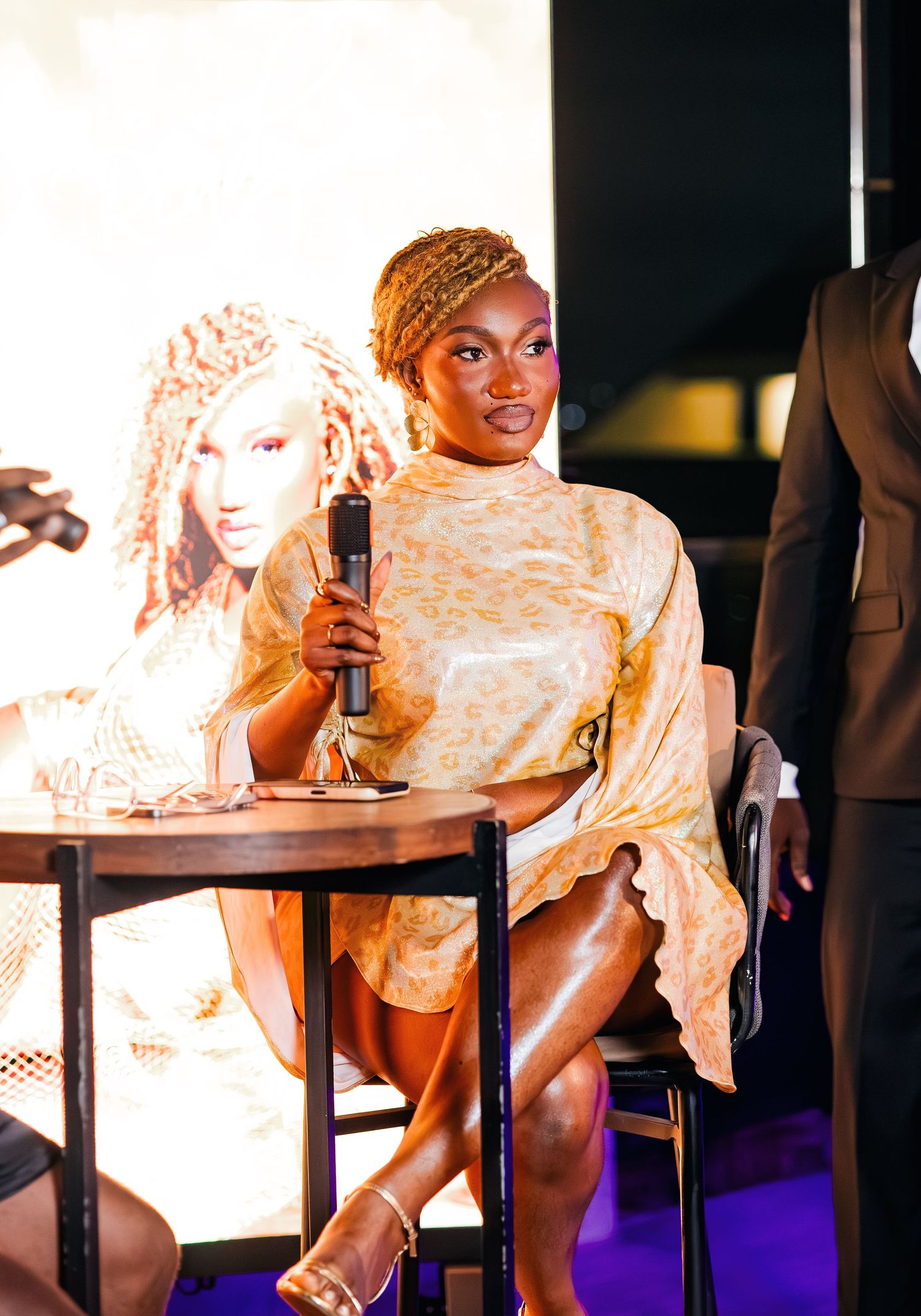 Performance scene with dramatic lighting and decorative backdrop on stage.