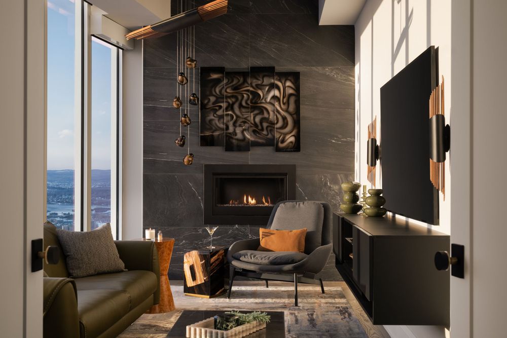 Modern luxury living room with ocean view features a stone fireplace, mounted TV, and contemporary leather furniture.