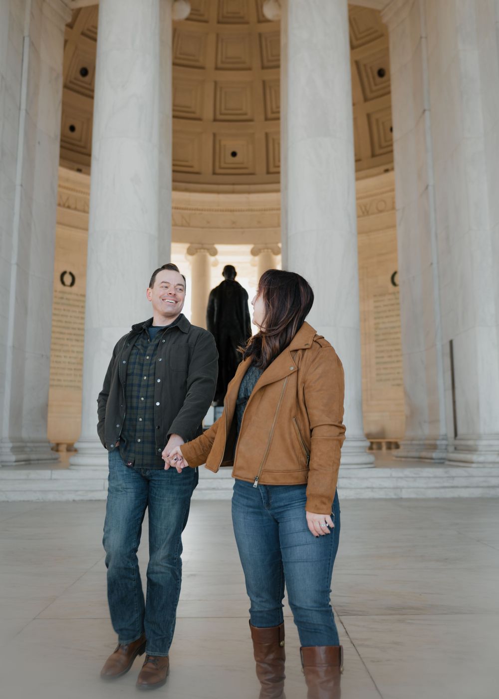 A couple shares a moment inside the Jefferson Memorial's columned interior.