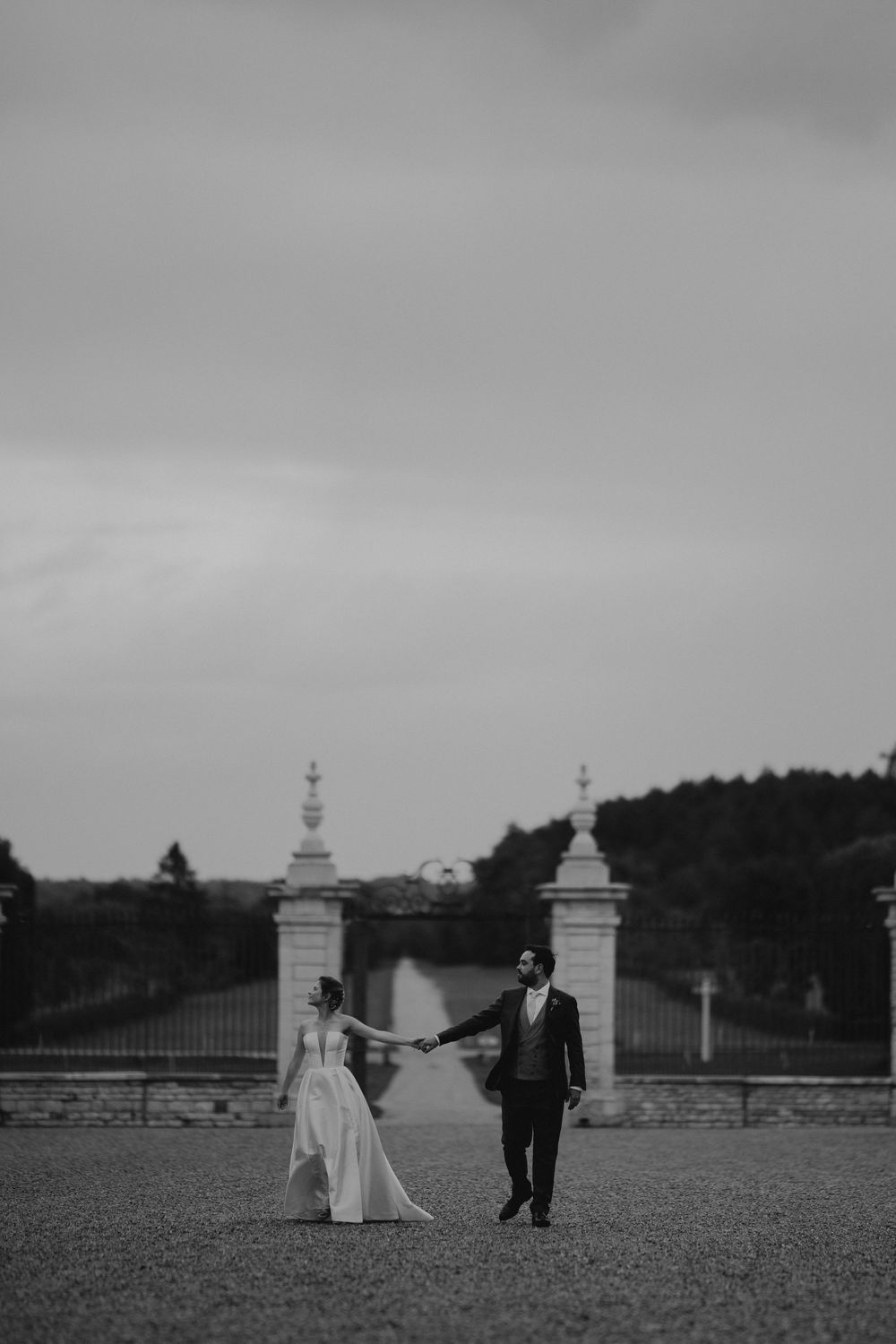 A romantic wedding photo sequence showing a couple in a grand outdoor setting with stone pillars.