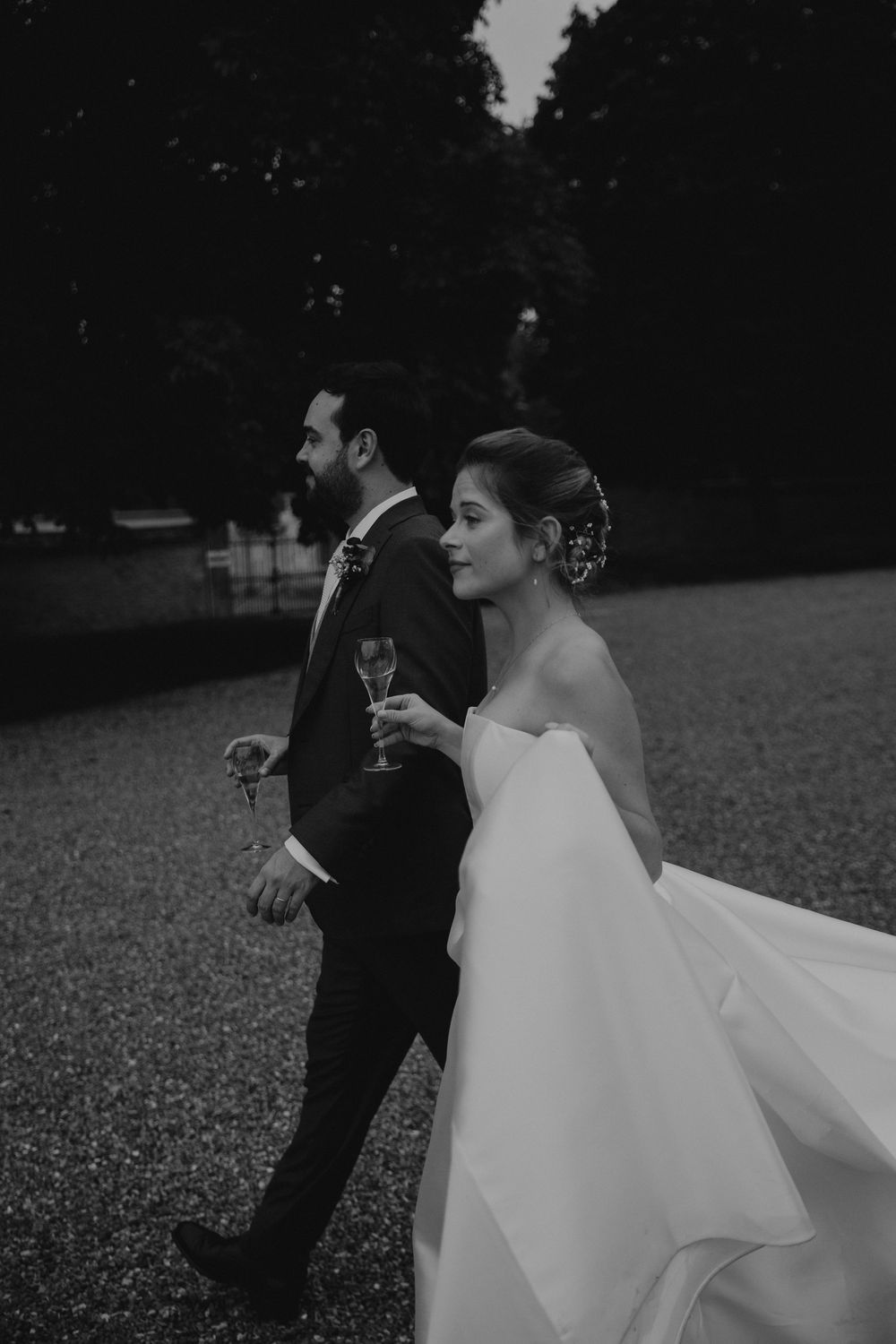 Black and white wedding portraits showing couple in dramatic poses outdoors.