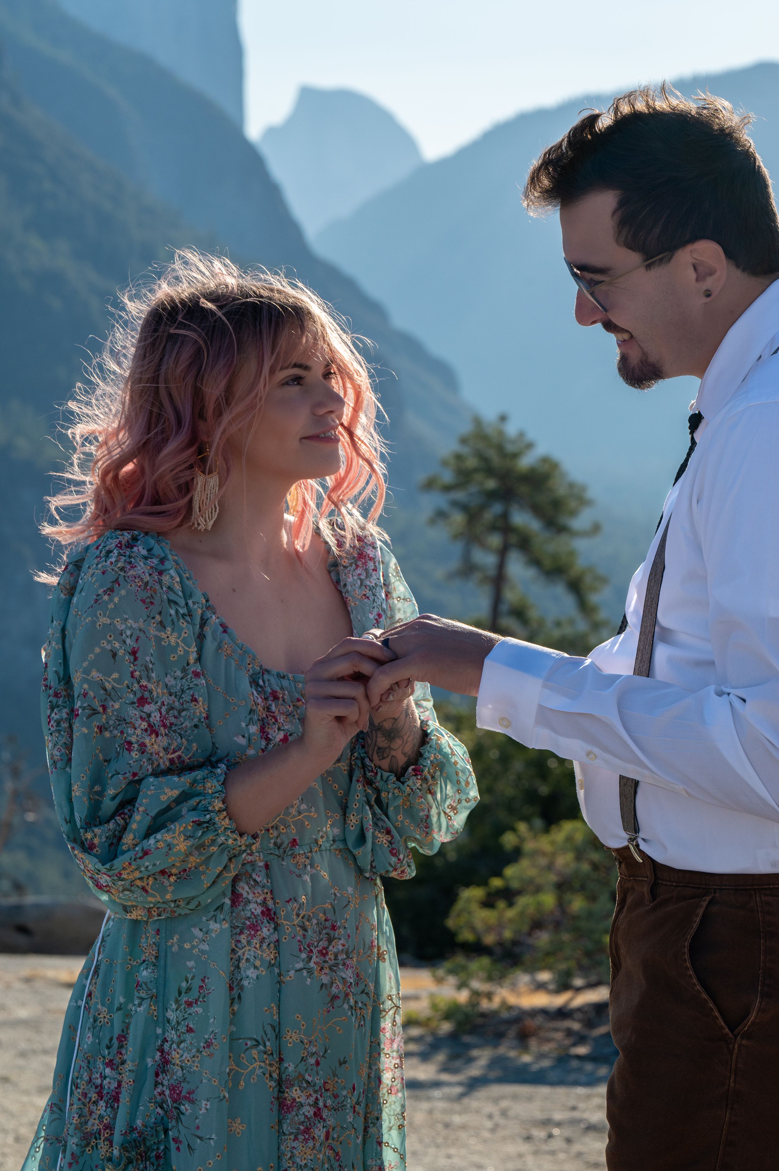 A romantic proposal moment captured against majestic mountain peaks.