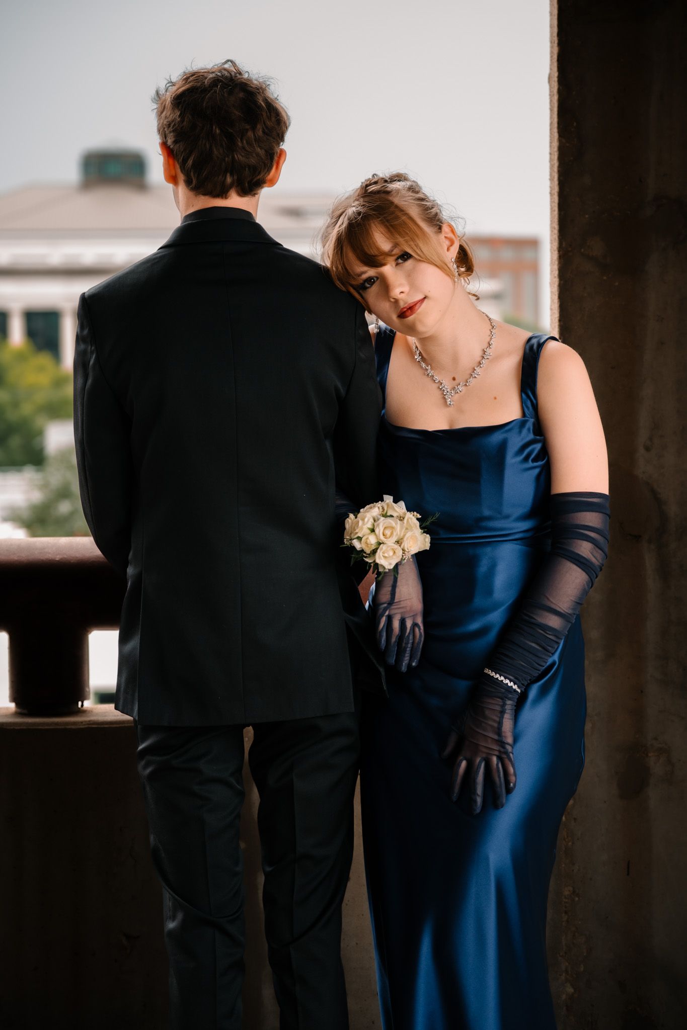 Bride and Groom kissing outside window Lafayette event space