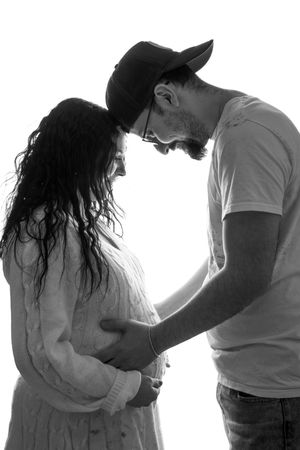 A series of black and white silhouettes showing an intimate couple embracing in different poses against a white background.