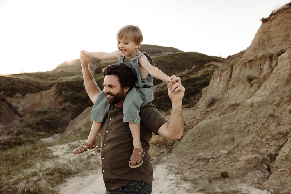 Dad and son play during a family photoshoot in calgary alberta