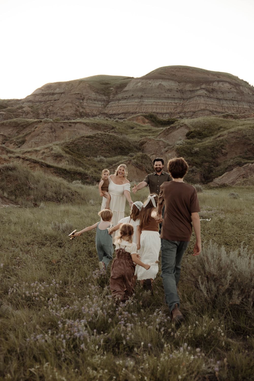 Children running towards their parents in alberta during family pictures