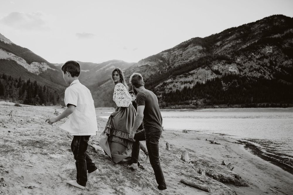 family portraits at barrier lake with mountain views and beautiful water