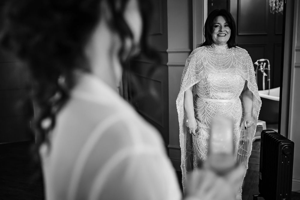 Black and white photo series showing a bride getting ready in her wedding dress and veil.