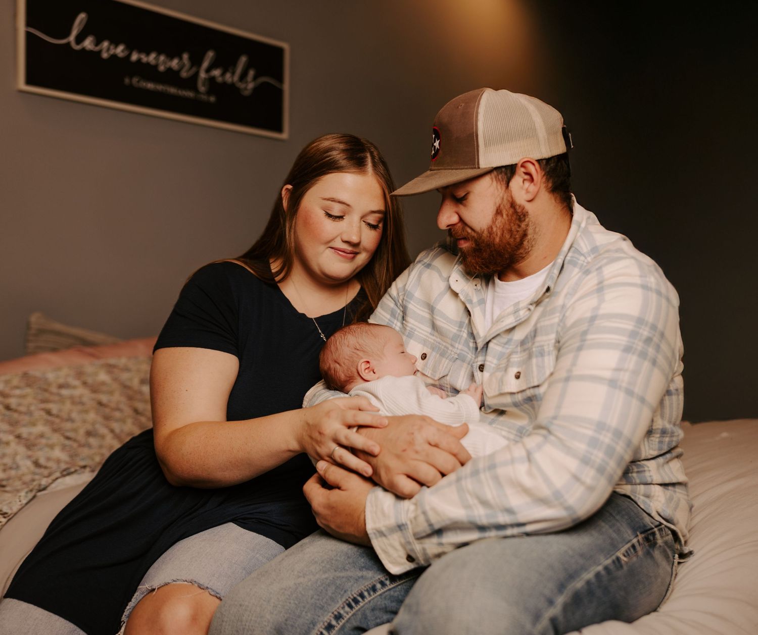 Intimate lifestyle photography with family members lounging on bed.