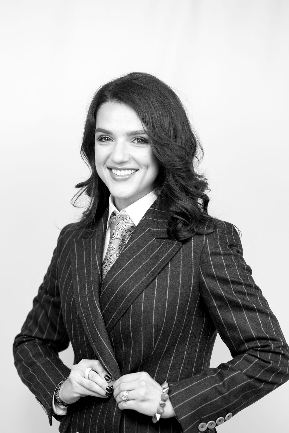 Professional portrait series showing different poses in a pinstripe suit against white background.