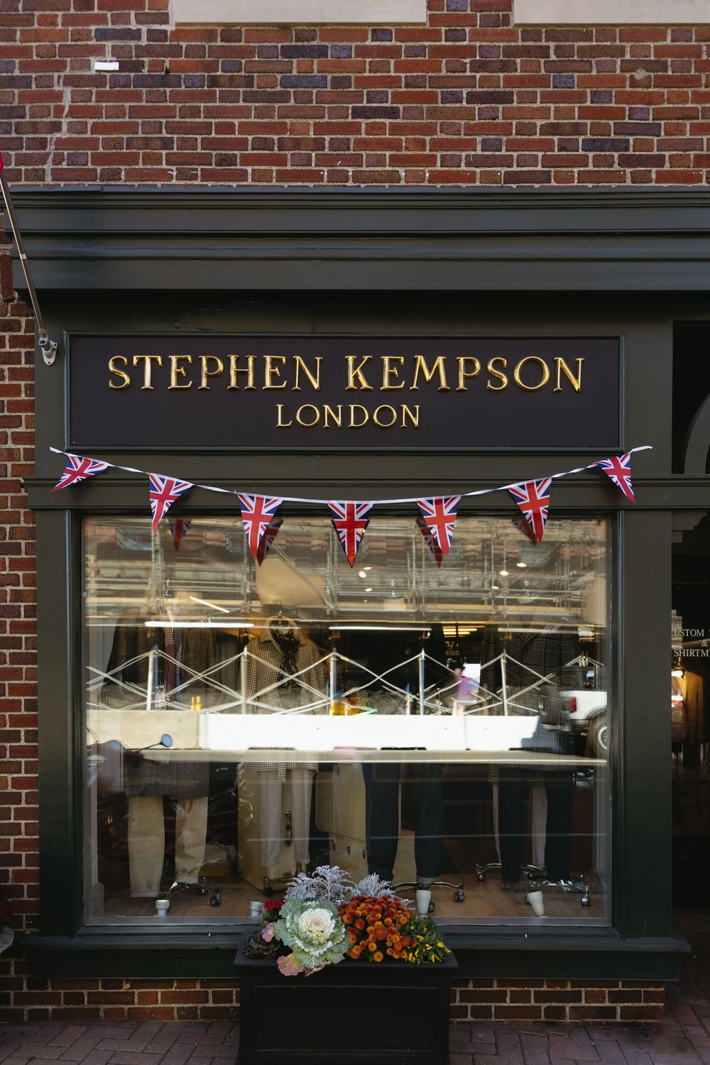 Stephen Kempson London storefront with British Union Jack bunting and red brick exterior in classic British style.