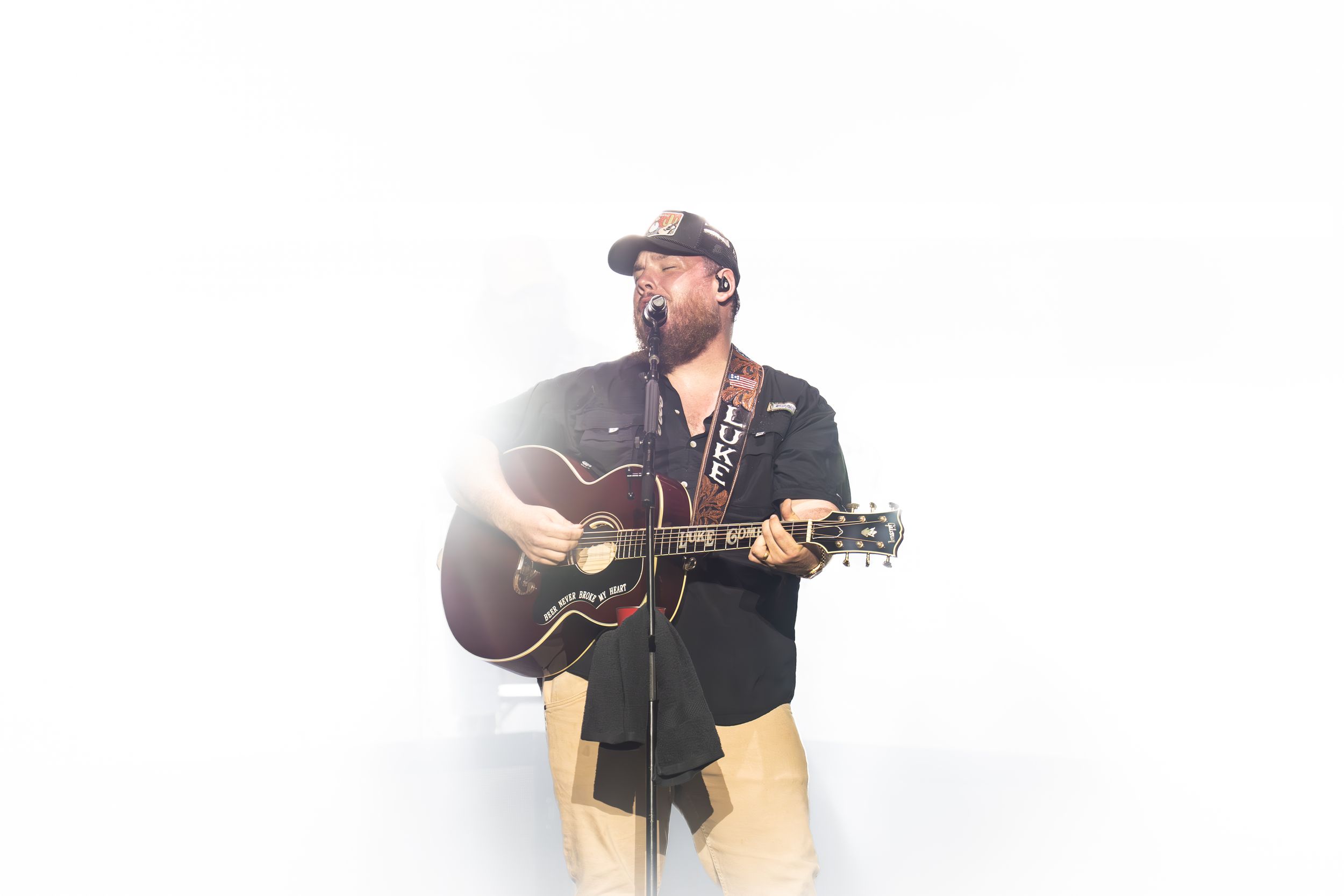 Musician in black shirt plays acoustic guitar in multiple poses during performance photo sequence.