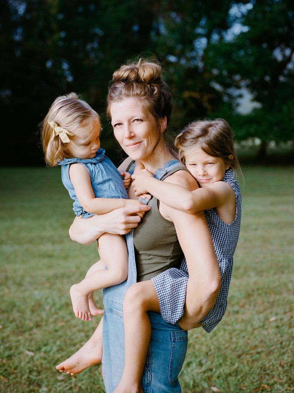 A playful sequence of photos shows a parent and child embracing and laughing together on a grassy lawn.