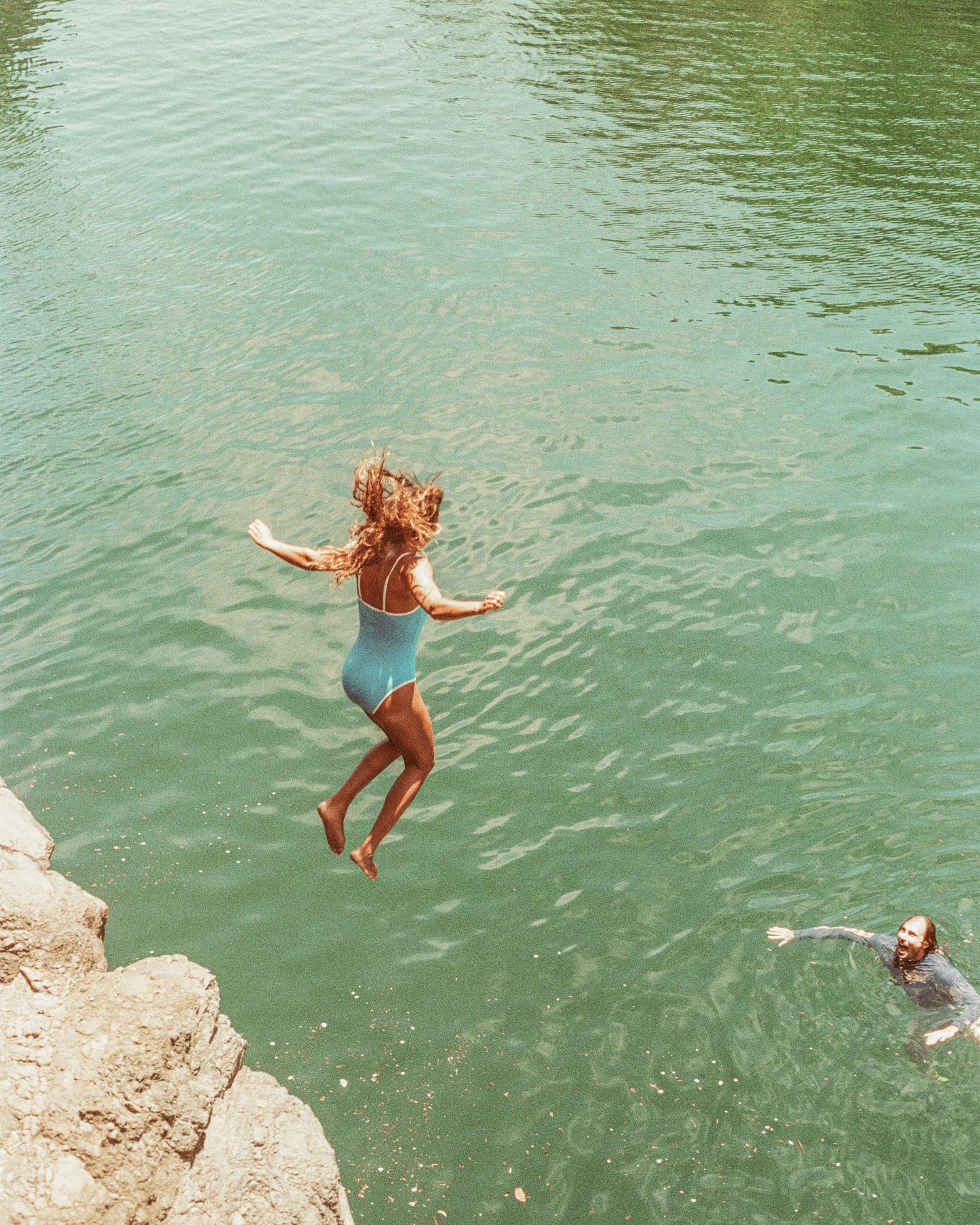A sequence of cliff jumping action shots shows someone diving into green-tinted water from a rocky ledge.
