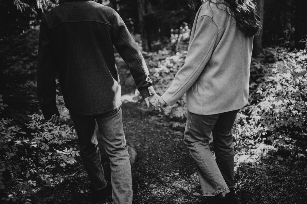 Engagement photographer of couple on Mt. Washington holding hands in Paradise Meadows for couple photoshoot Vancouver Island