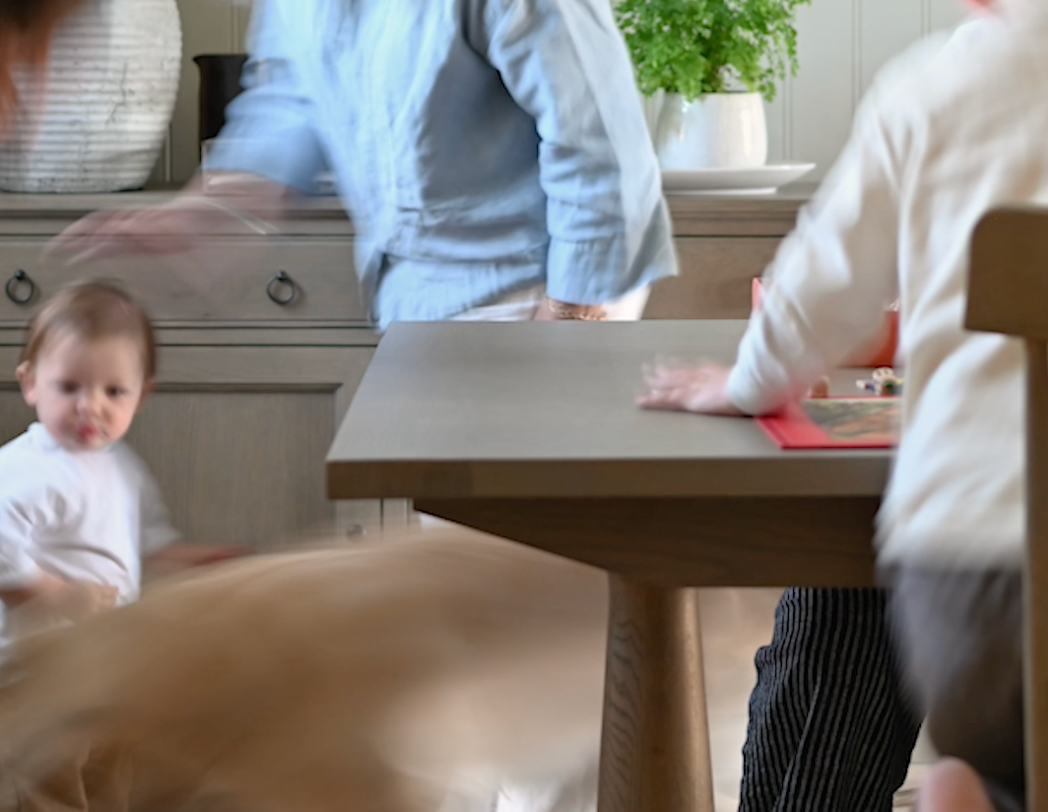 Family rush around a table setting with blurred movement