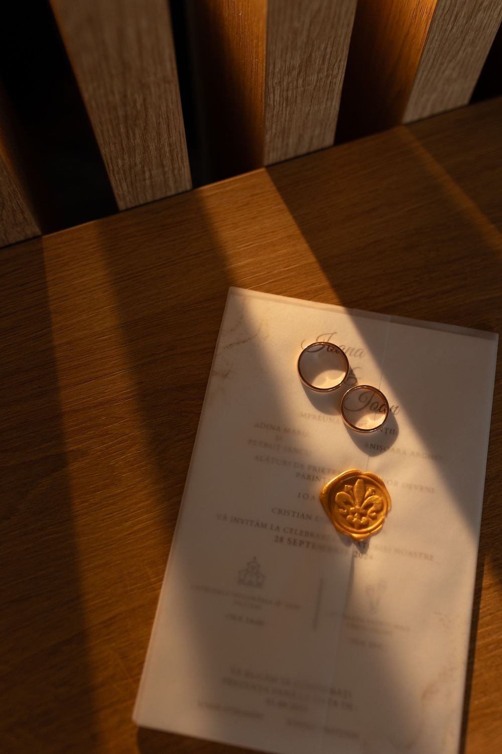 Wedding rings casting dramatic shadows on white paper in sequence of artistic detail shots.