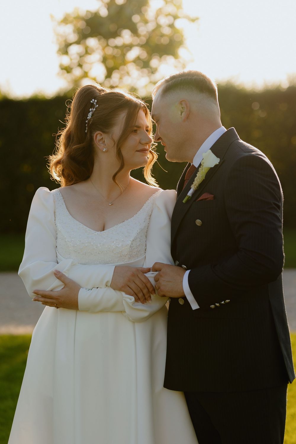 Romantic sunset wedding portraits with couple sharing intimate moments in golden hour lighting.