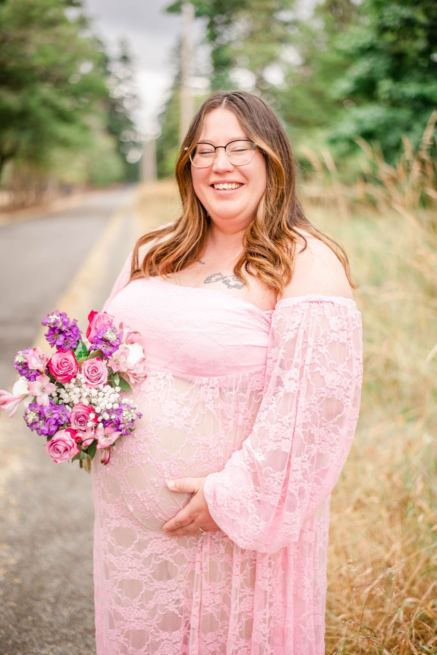Dreamy outdoor photoshoot with pink lace dress and vibrant purple and pink floral bouquet against natural backdrop.