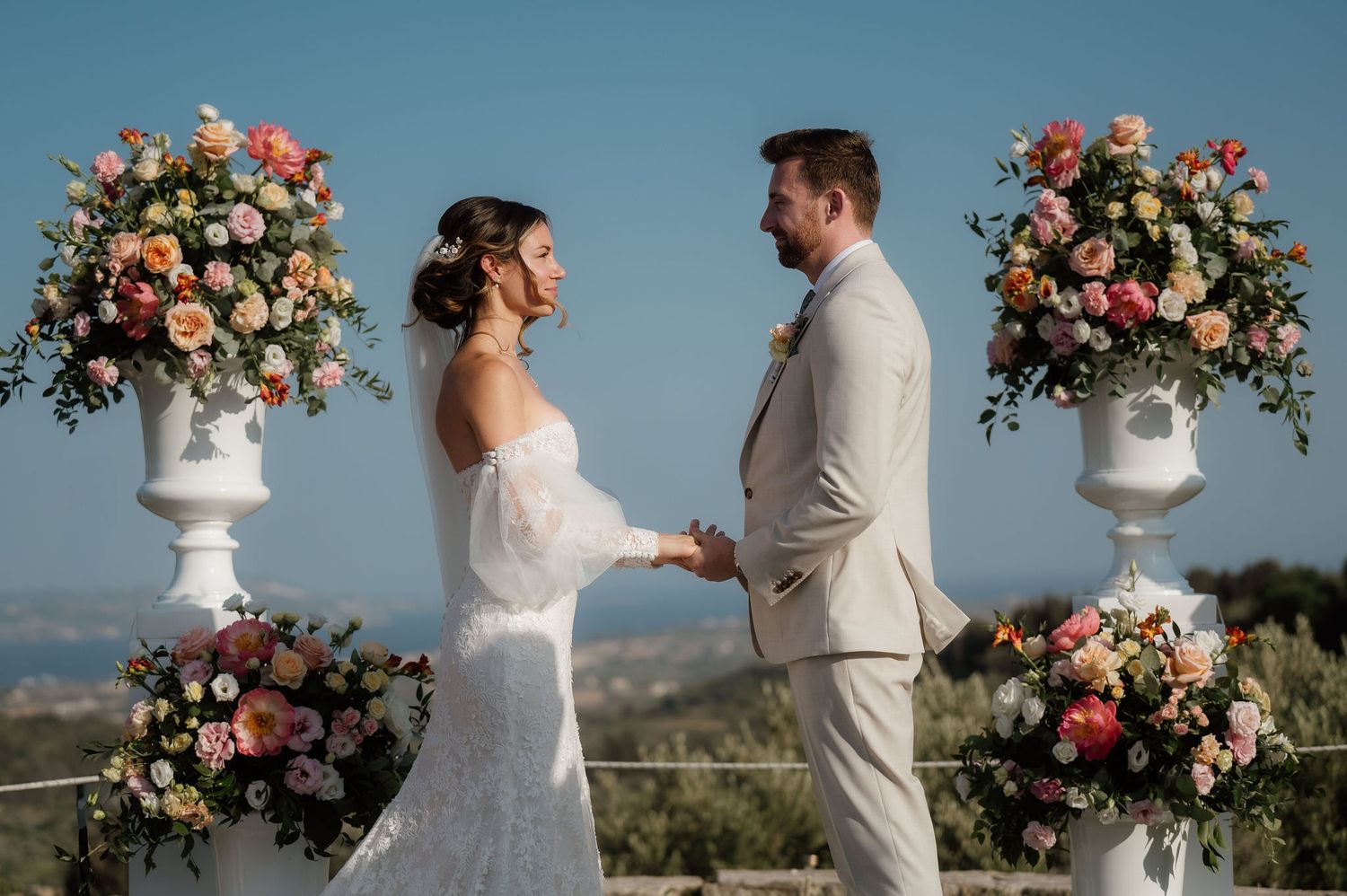 A photo of a bride and groom exchanging vows at their wedding ceremony in Kefalonia Greece