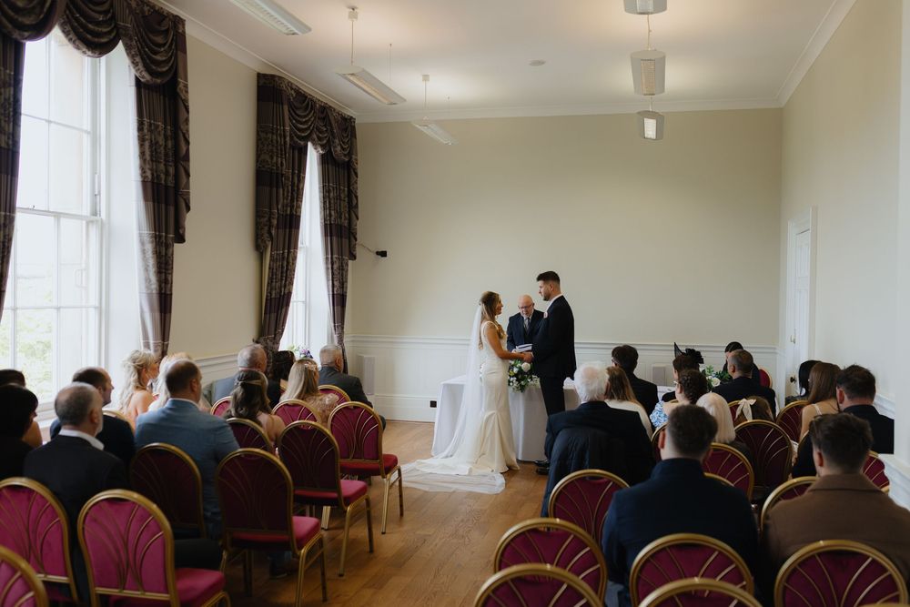 A series of photos showing a formal conference or meeting room with rows of chairs and attendees.
