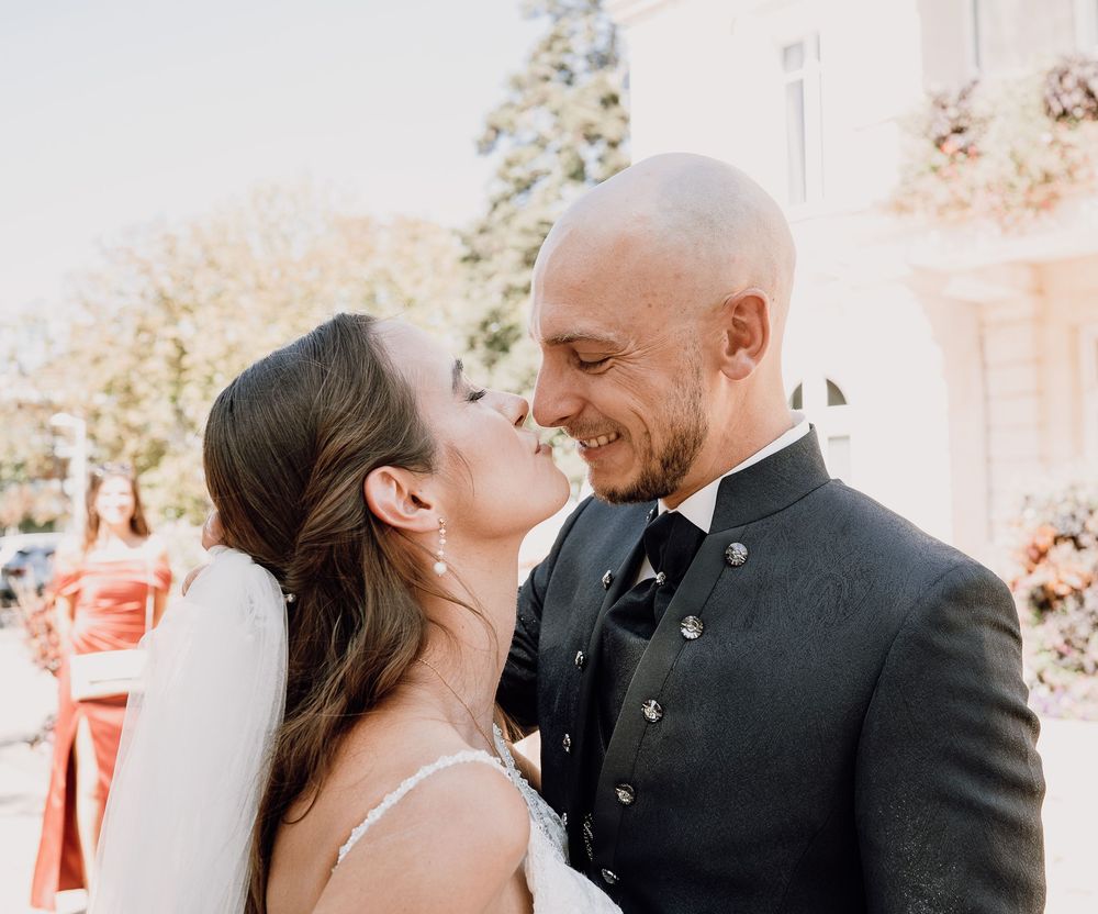 A romantic wedding couple shares intimate moments in a series of candid outdoor photographs.
