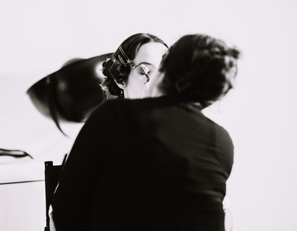 Black and white photo sequence showing silhouettes of two people in an intimate dance pose against a light background.