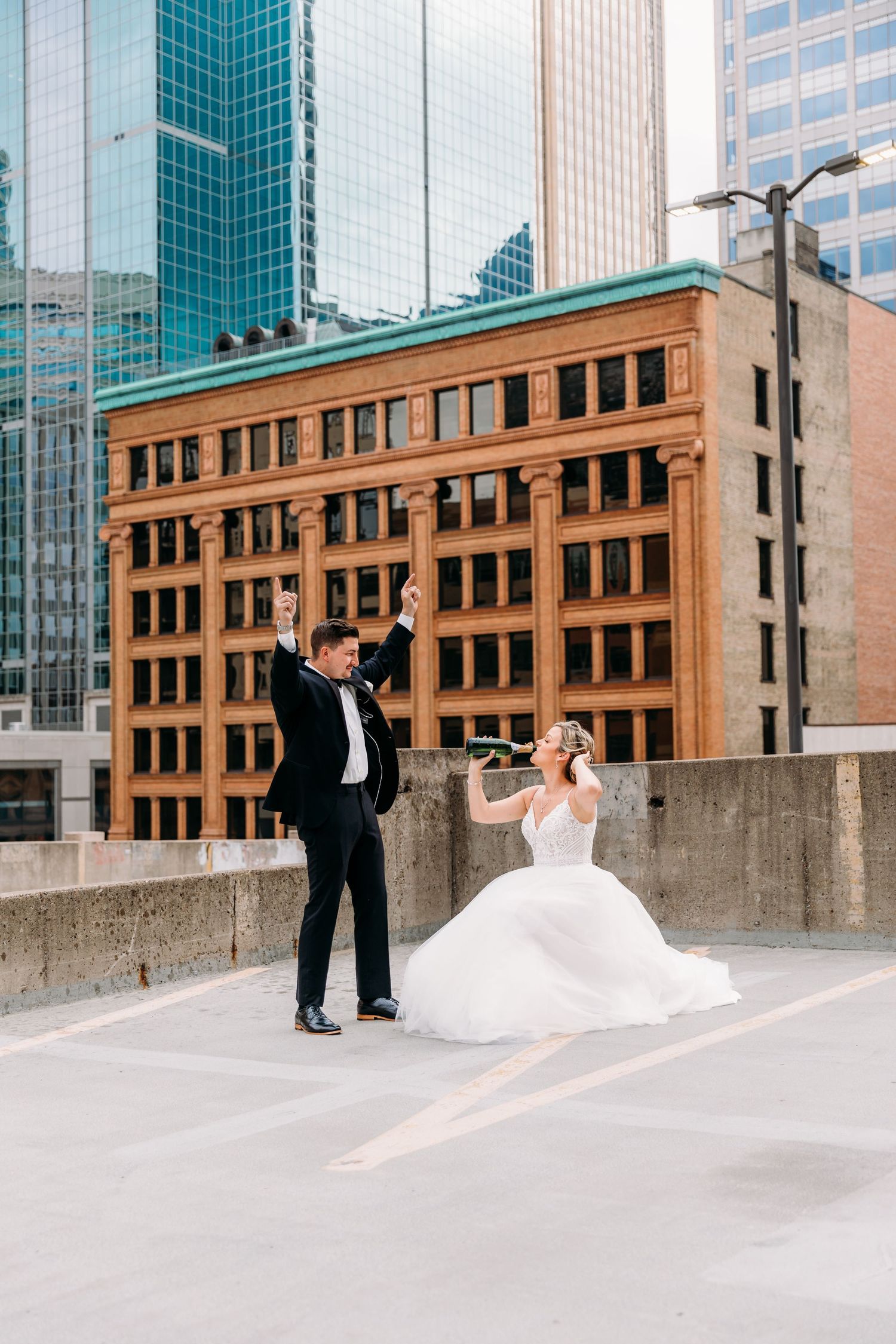 A series of playful wedding photos captured against modern city buildings with glass facades.