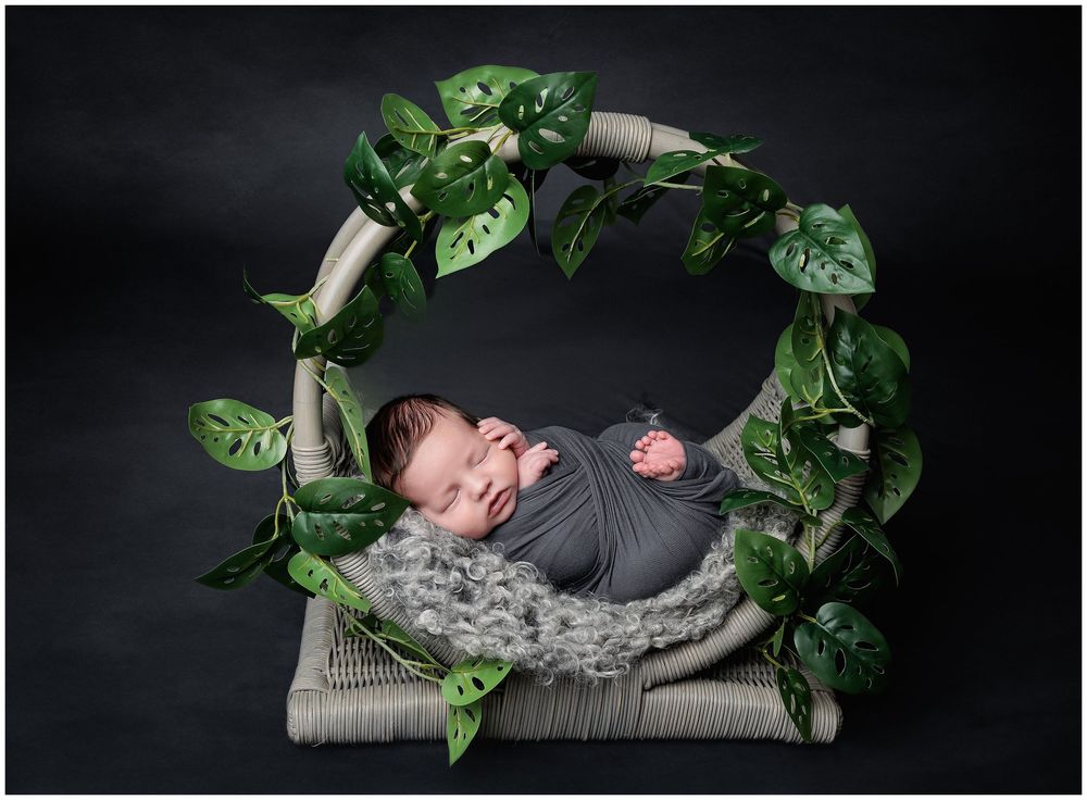 Artistic newborn portrait in green floral wreath setup photographed in Austin studio by Valerie Kay Photography