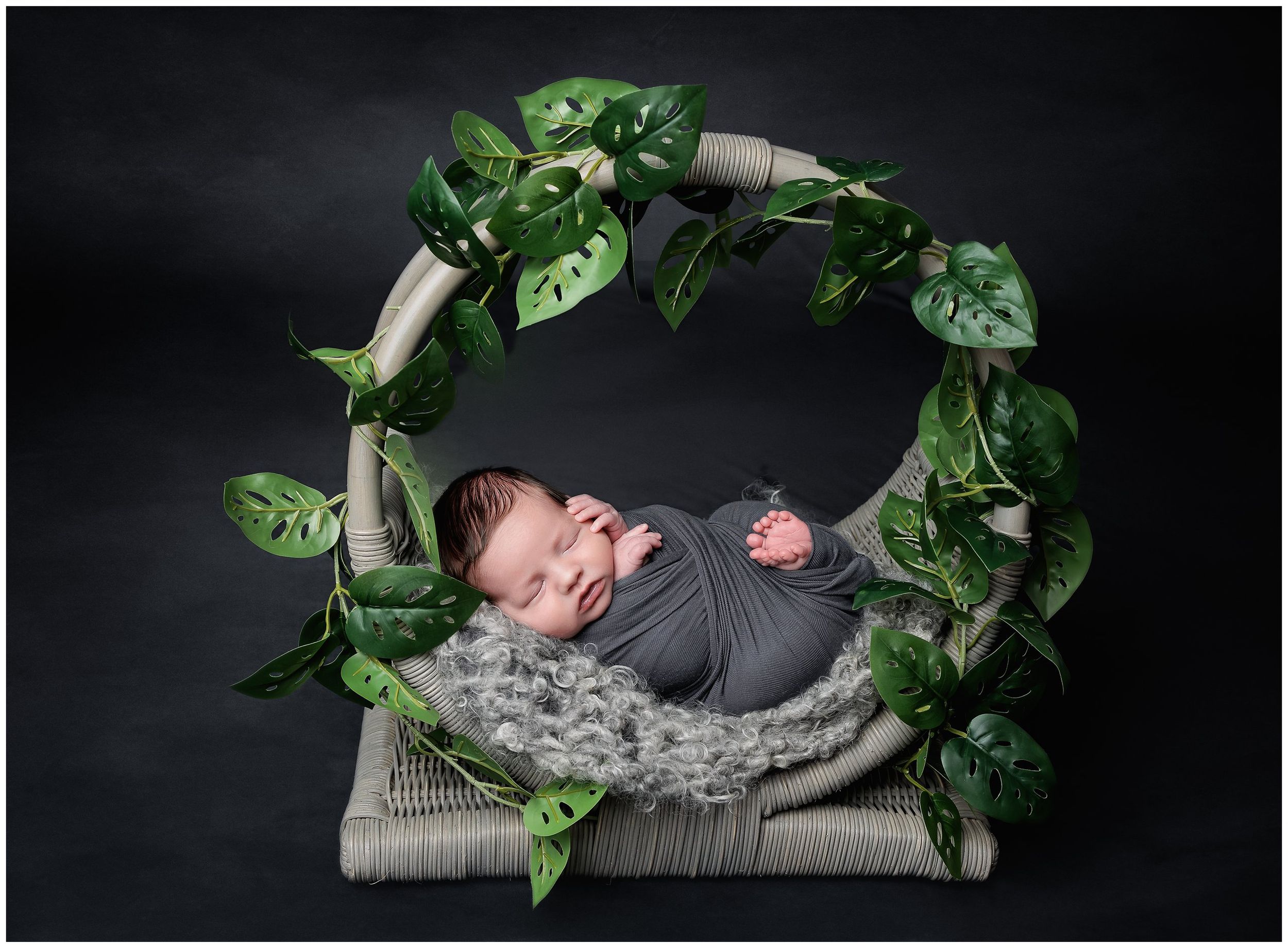 Artistic newborn portrait in green floral wreath setup photographed in Austin studio by Valerie Kay Photography