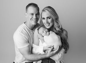 Black and white newborn family portrait of parents holding baby in studio photographed by Valerie Kay Photography Austin