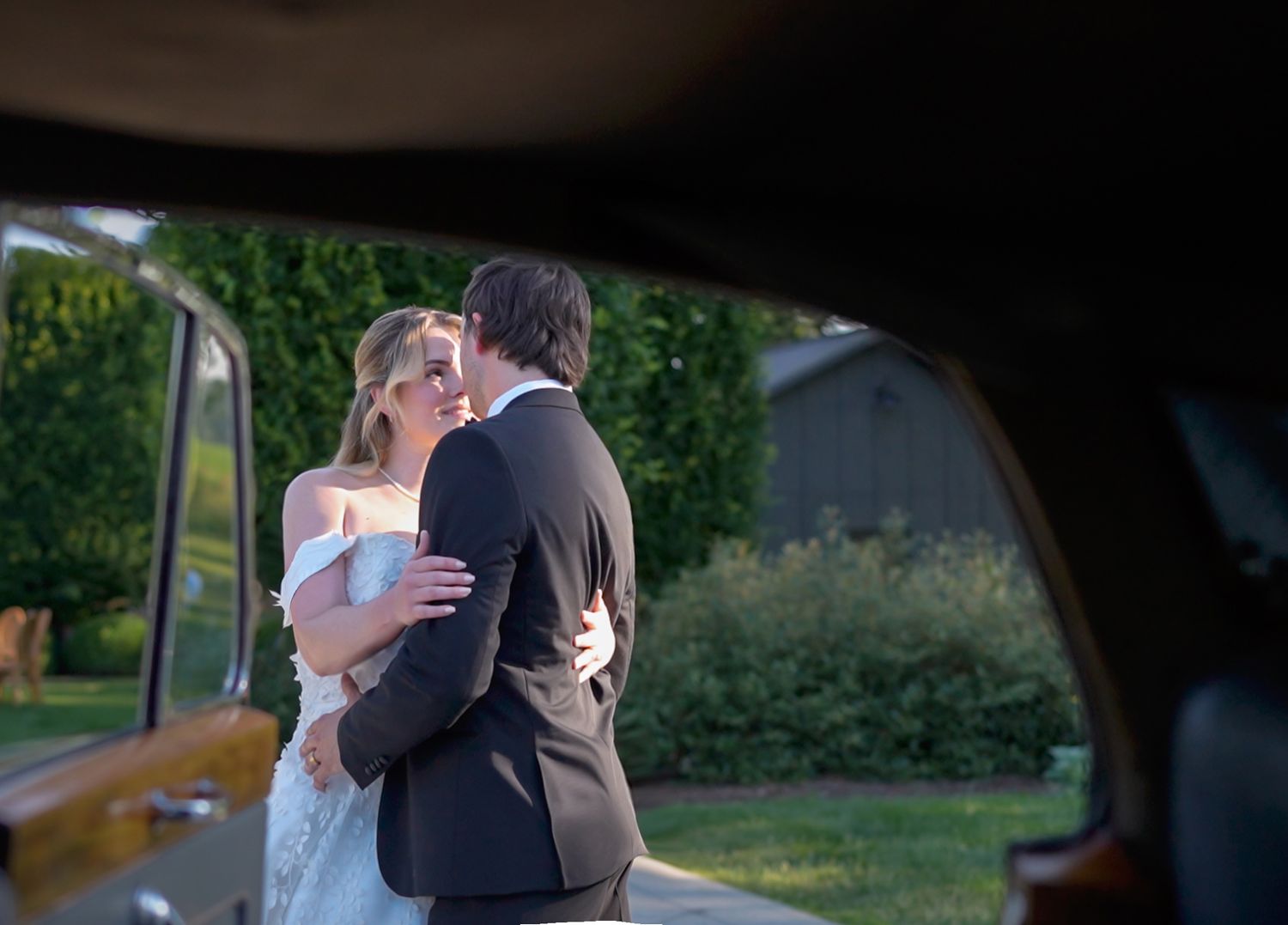 Bride and groom share a romantic kiss beside at Jorgensen farms