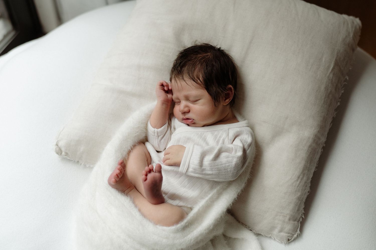 baby relaxed pose on beanbag, lifestyle Auckland newborn photoshoot