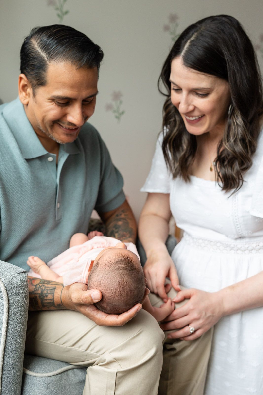 Parents smiling at baby in their Seattle home.