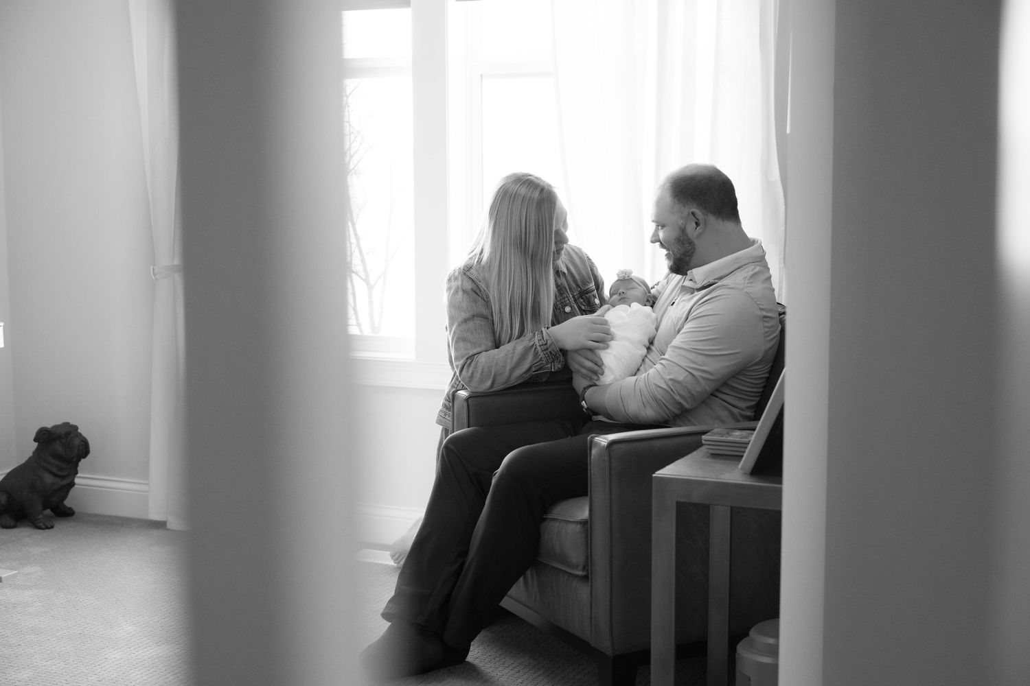 candid photo of parents admiring newborn baby during in home lifestyle newborn session in lake elmo, mn