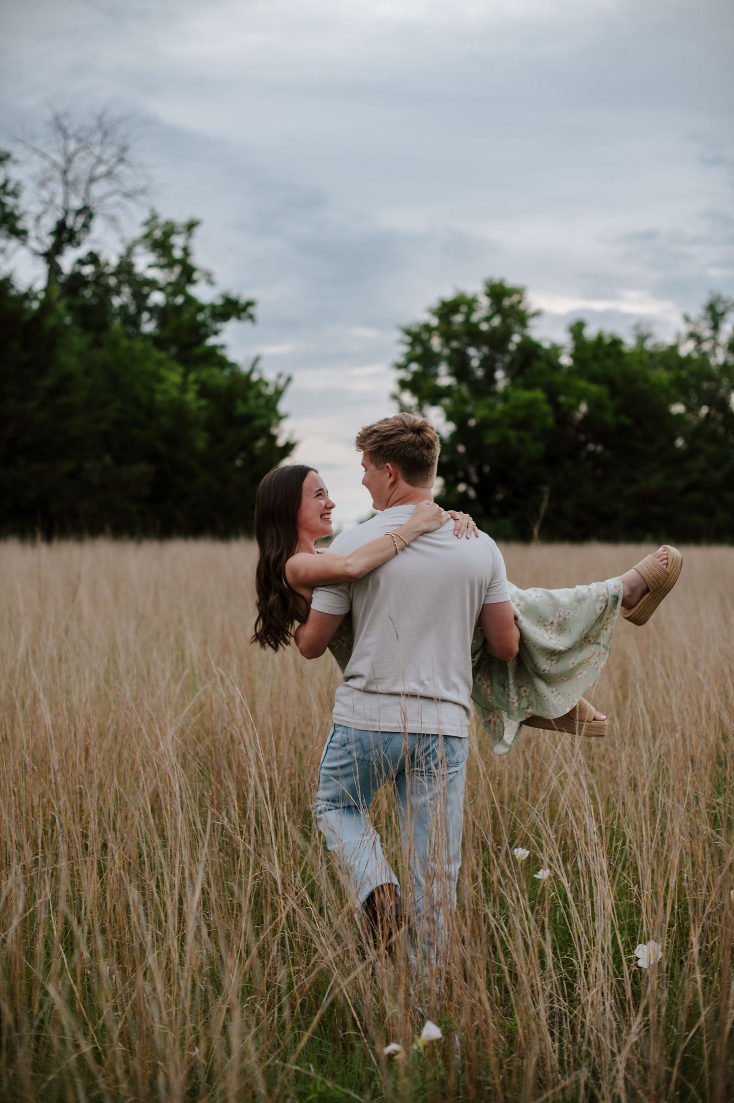 Wichita KS outdoor engagement photos in nature location Andover, couple photos in field with flowers, small elopement wedding photographer