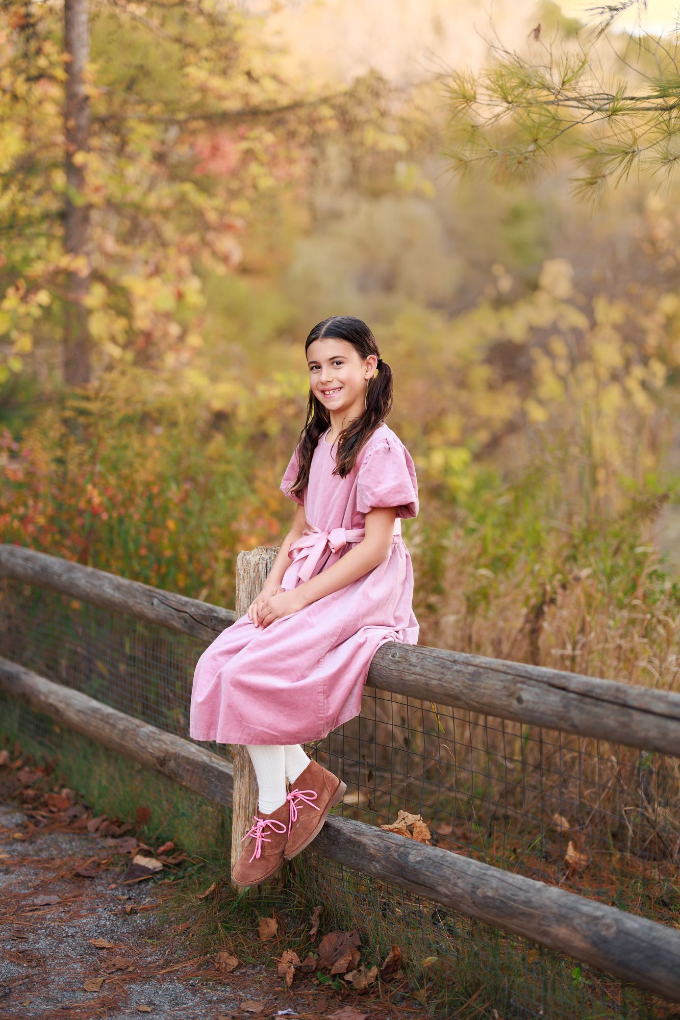 Child portrait of a girl in a pink dress during an outdoor fall photo session in Toronto