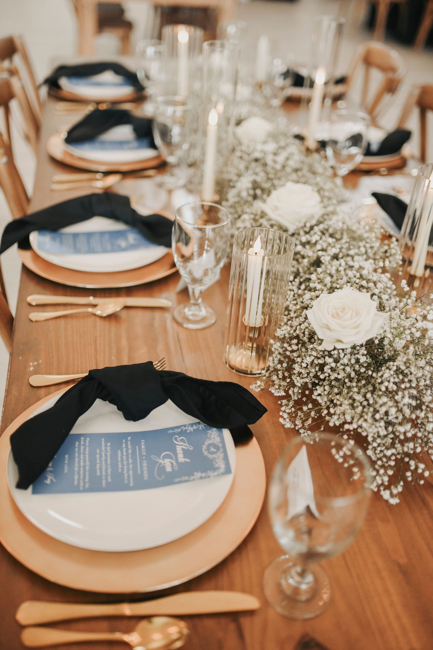 Elegant reception decor featuring candlelit farmhouse tables