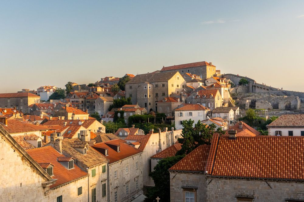 Sunset view over terracotta rooftops in Dubrovnik's historic old town.