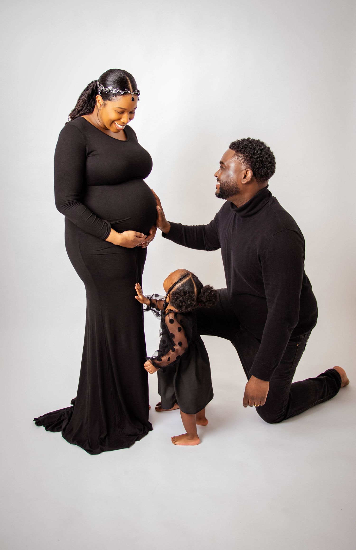 Romantic proposal photoshoot with couple in matching black outfits.