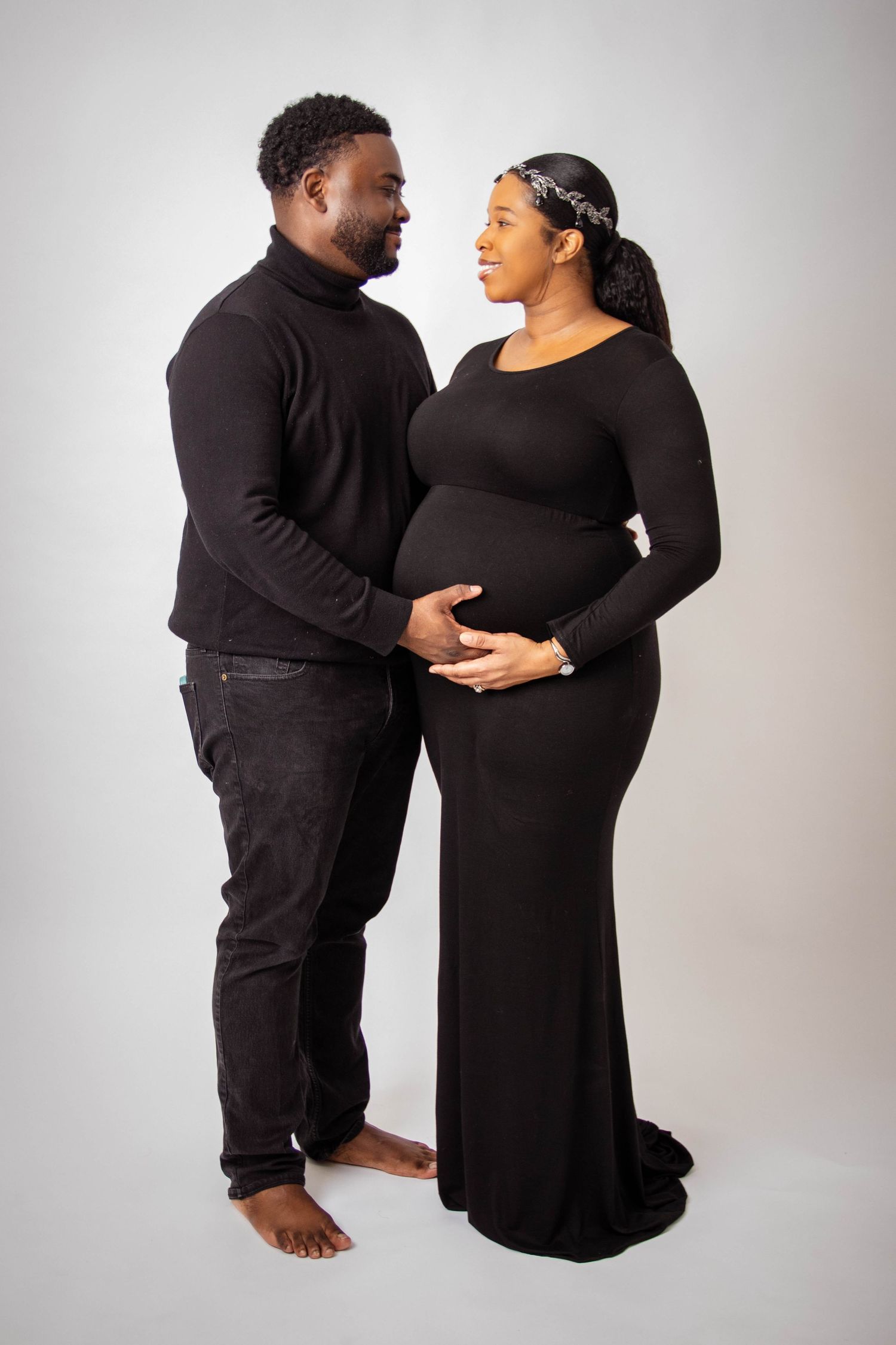 Intimate couple's portrait session in coordinated black outfits.