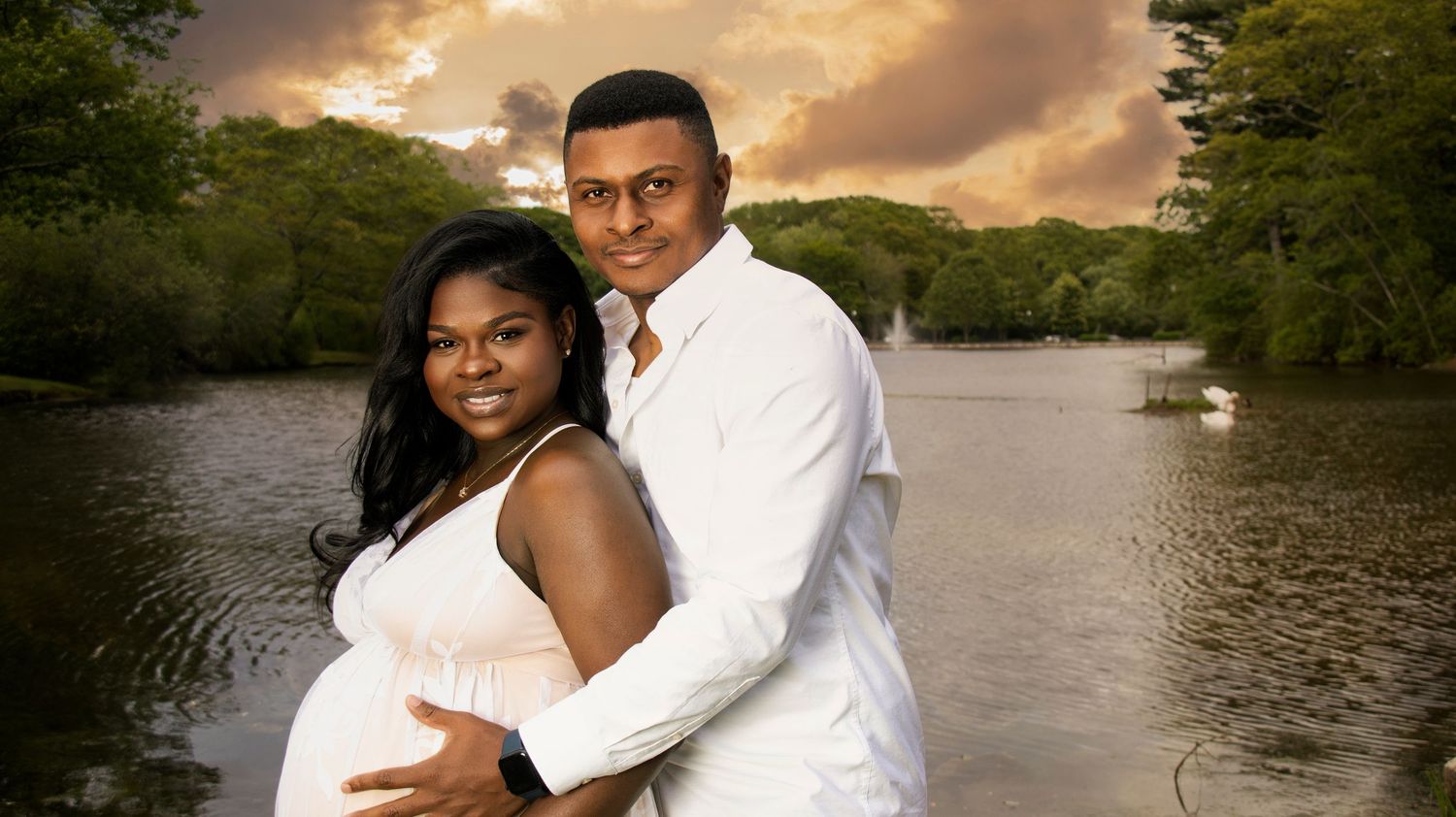 Romantic sunset engagement photoshoot by a lake with couple in formal attire.