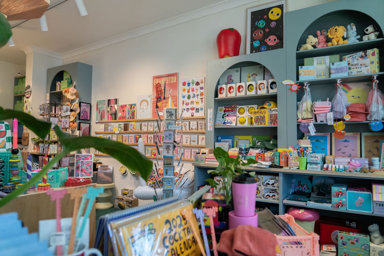 Colorful retail bookstore interior with shelves of books and decorative displays.