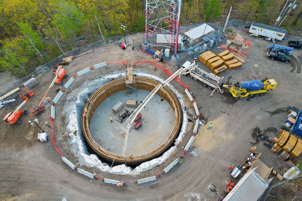 Overhead shot of circular construction project with machinery and materials.
