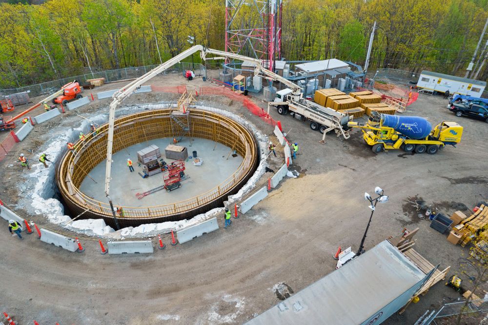 Aerial photograph of ring-shaped construction development with equipment and supplies.