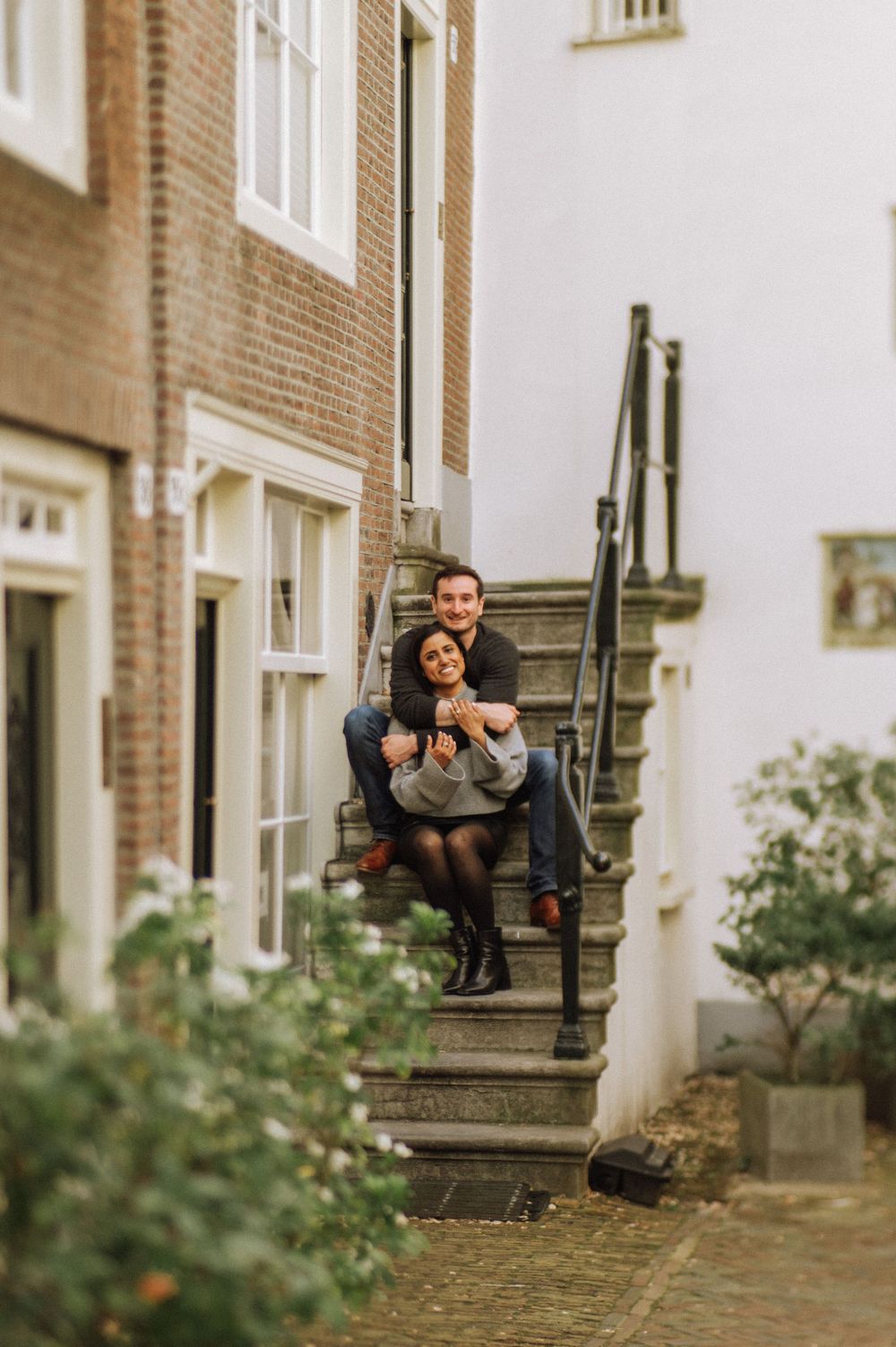 A sequence of images showing someone sitting on stone steps outside a brick building.