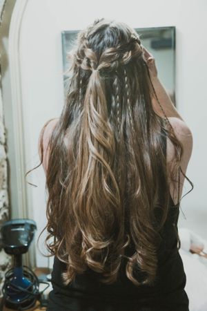 Intricate braided hairstyle with long flowing waves shown from behind.